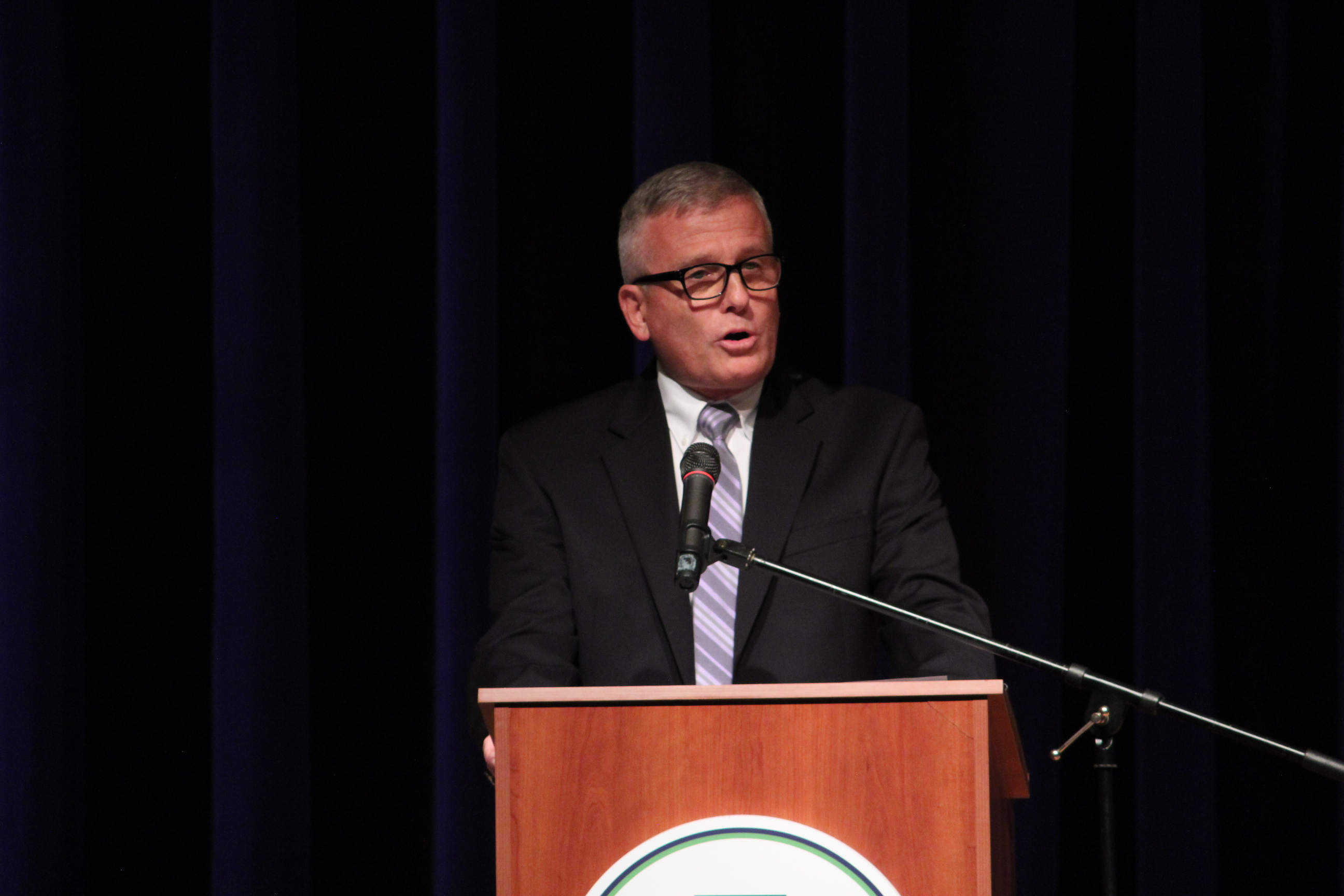 Dr. Ruddy speaking at a podium